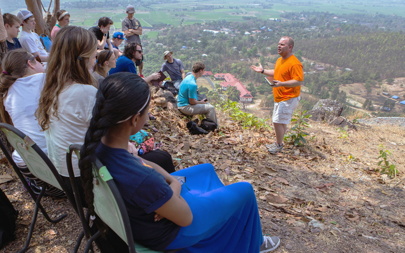 A group hiking the mountain trail above the campus