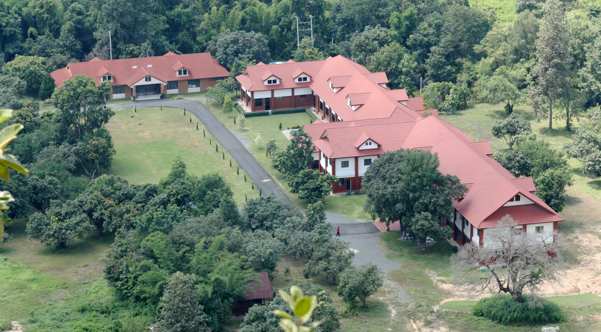 Aerial view of The Kalnin Center campus in Doi Saket surrounded by forest